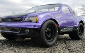 URCG Edition - Traxxas Slash 4x4, JConcepts body - Purple Ford 99 Lightning, ProLine Prime Tires - named Purple Lightning (front view)