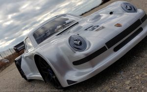 URCG Edition - Traxxas Slash 4x4, Delta Plastik USA body - Silver Porsche 911 GT3, Sweep Racing Tires - named Tuxedo Rob (front view)