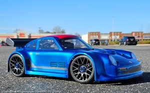 URCG Edition - Traxxas Slash 4x4, Delta Plastik USA body - Metallic Blue Porsche 911 GT3, Sweep Racing Tires - named SixThree