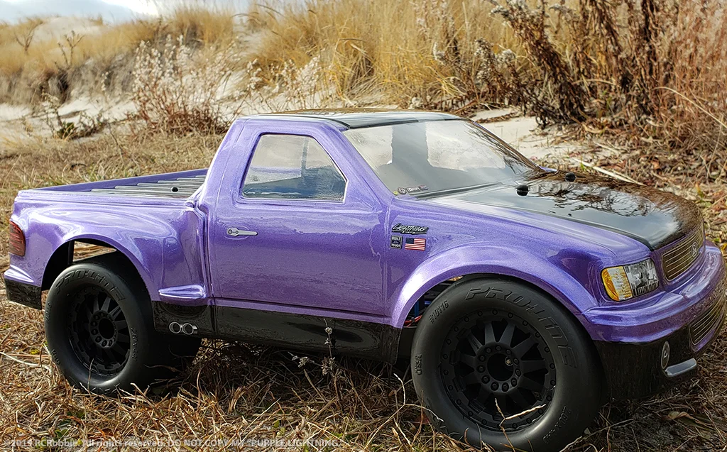 URCG Edition - Traxxas Slash 4x4, JConcepts body - Purple Ford 99 Lightning, ProLine Prime Tires - named Purple Lightning (side view)